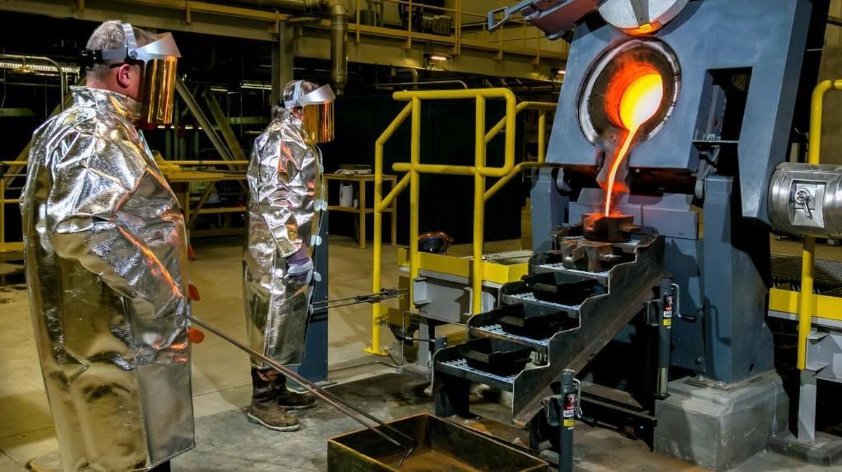 Members of OceanasGold’s Haile metallurgical team oversees the pouring of molten gold early Friday morning. The Haile Gold Mine is located in Lancaster County