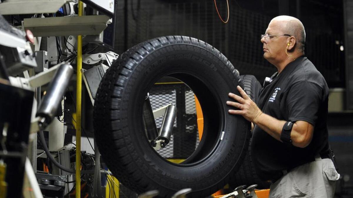 A tire inspector checks for defects at a Michelin manufacturing plant in Greenville.