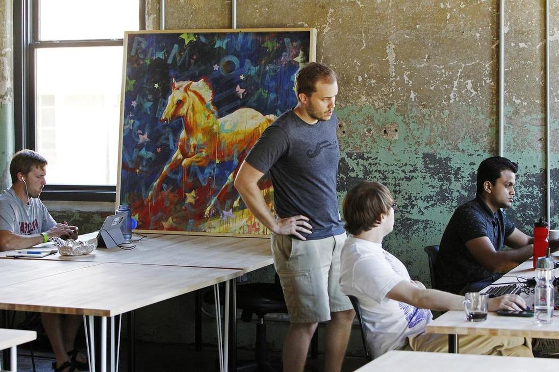 Employees of Krumware, a tech company that creates software solutions which can enable realtime data and content distribution for both the enterprise and the individual, gather inside their new home inside the Bakery at BullStreet development.