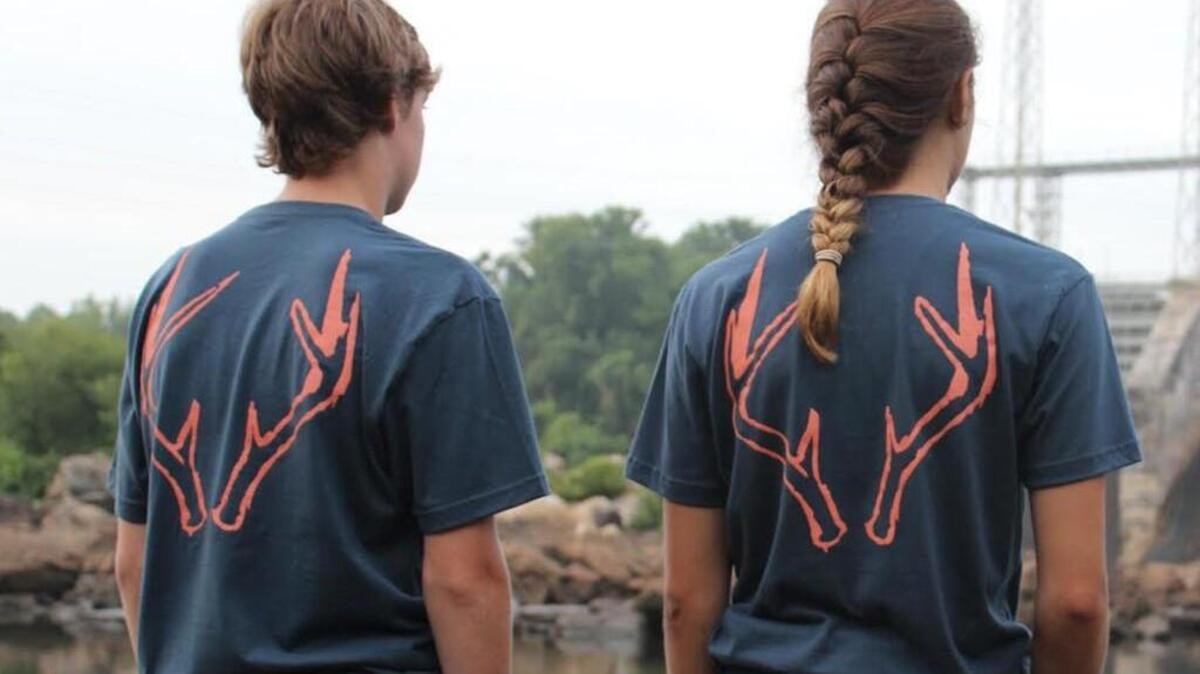Fort Mill teenagers Trevor Gray, left, and Olivia Lininger model Don Raven T-shirts designed by their friend and company founder, 17-year-old Ezekiel MacMillan.