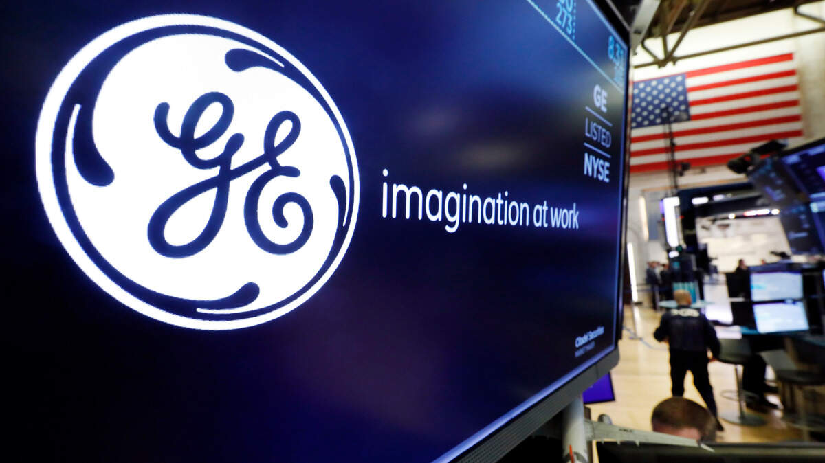 The logo for General Electric appears above a trading post on the floor of the New York Stock Exchange, Friday, Aug. 16, 2019. General Electric rebounded 6.7% after reporting late Thursday that its CEO had bought 250,000 shares of GE stock. GE had taken a plunge on new concerns about its accounting practices. (AP Photo/Richard Drew)