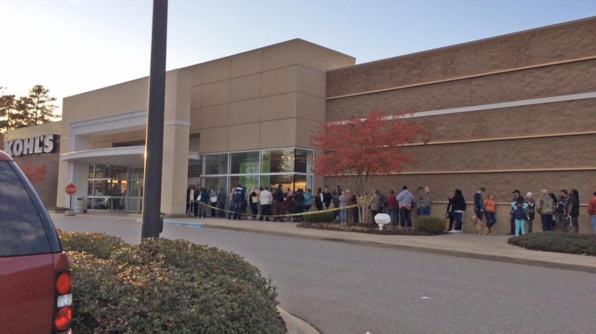 People wait in line outside of Kohl’s on Thanksgiving Day in order to take advantage of the start of holiday sales before Black Friday.