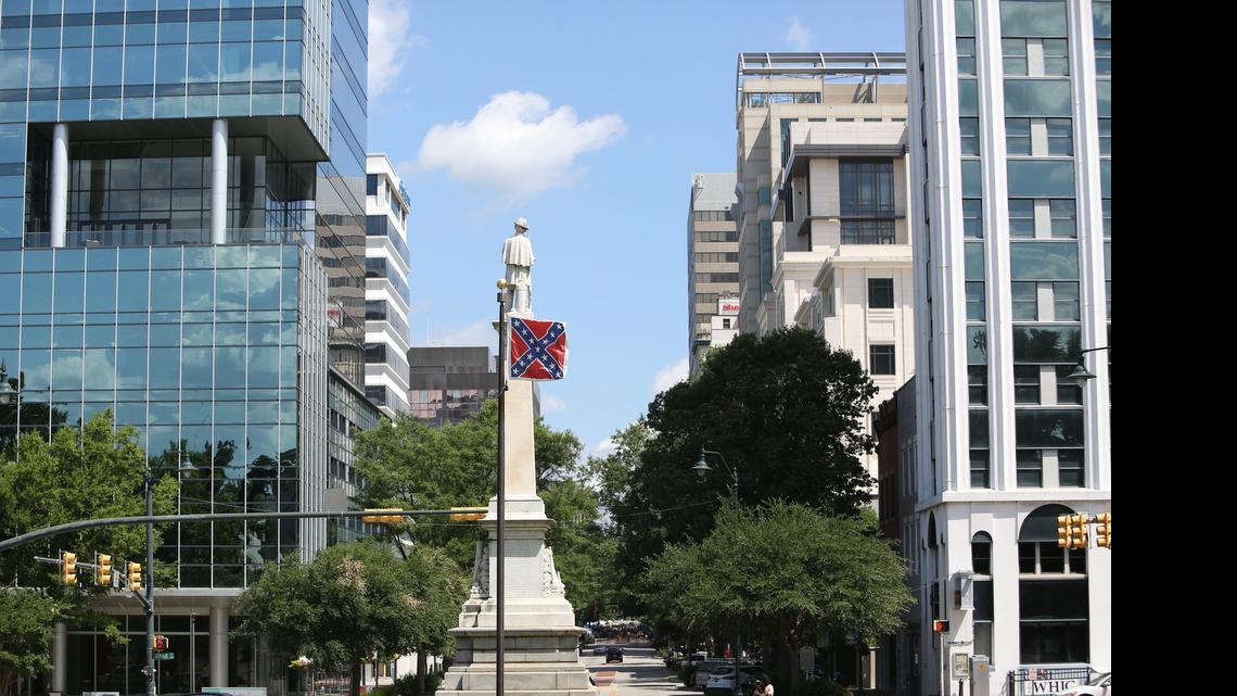 
The Confederate battle flag flies in front of the South Carolina State House at a Confederate memorial. 
