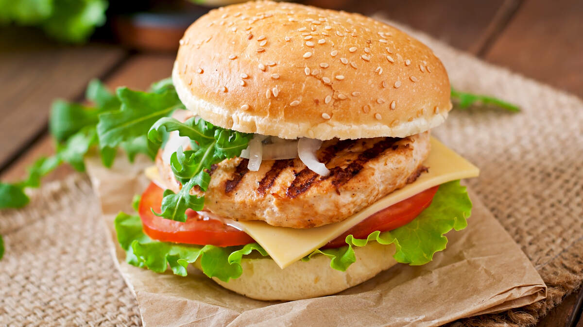 Sandwich with chicken burger, tomatoes, cheese and lettuce