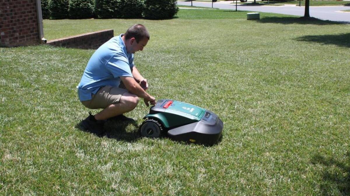HomeVP co-founder Nick Sagnella is shown using an app to put a robotic lawn mower in demonstration mode