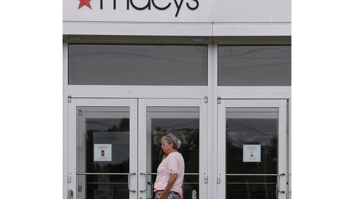 
In this Friday, July 10, 2015 photo a woman walks up to the doors of a Macy's department store in Hanover, Mass. 

