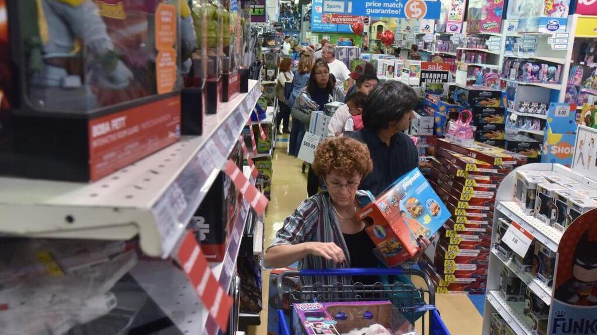 Early Black Friday shoppers stand in line to check out on November 24, 2016, at Toys R Us at Town Center in Kennesaw, Ga. In 2017, Toys R Us will open 5 p.m. Thanksgiving Day and remain open until 11 p.m. Black Friday.