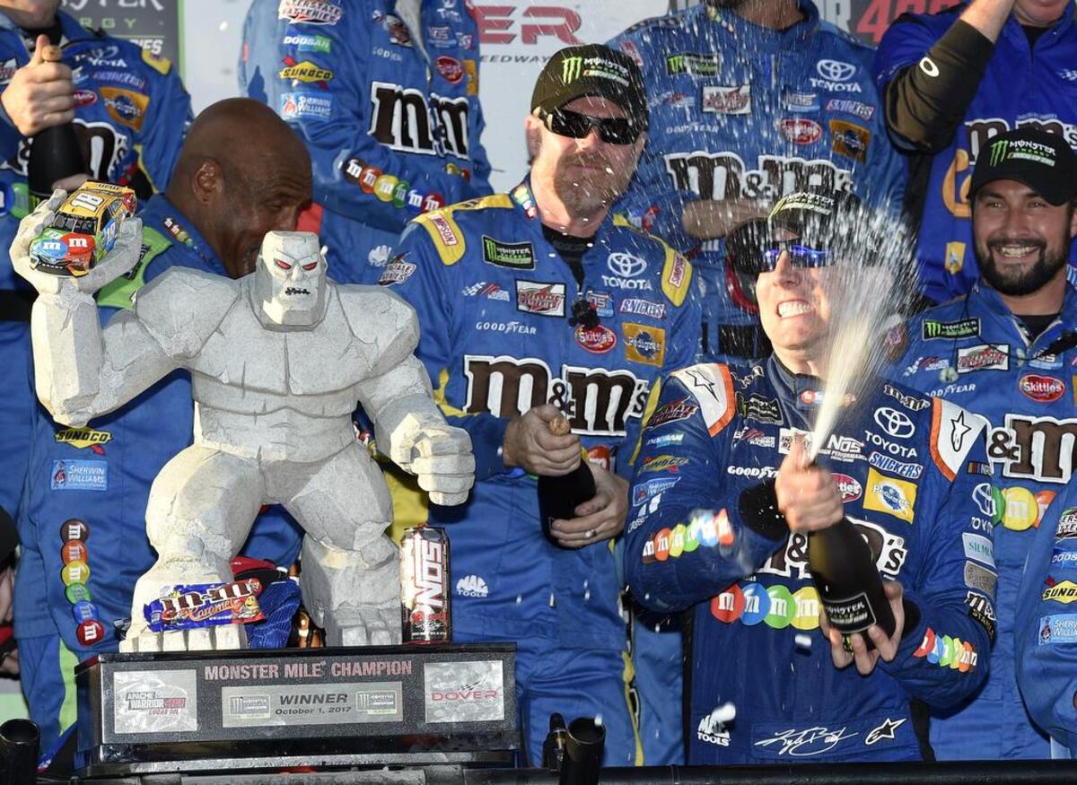 Kyle Busch, front right, celebrates in Victory Lane after winning a NASCAR Cup series auto race Oct. 1 at Dover International Speedway in Dover, Del. Corporate sponsors like M&M’s play an especially important role in NASCAR.