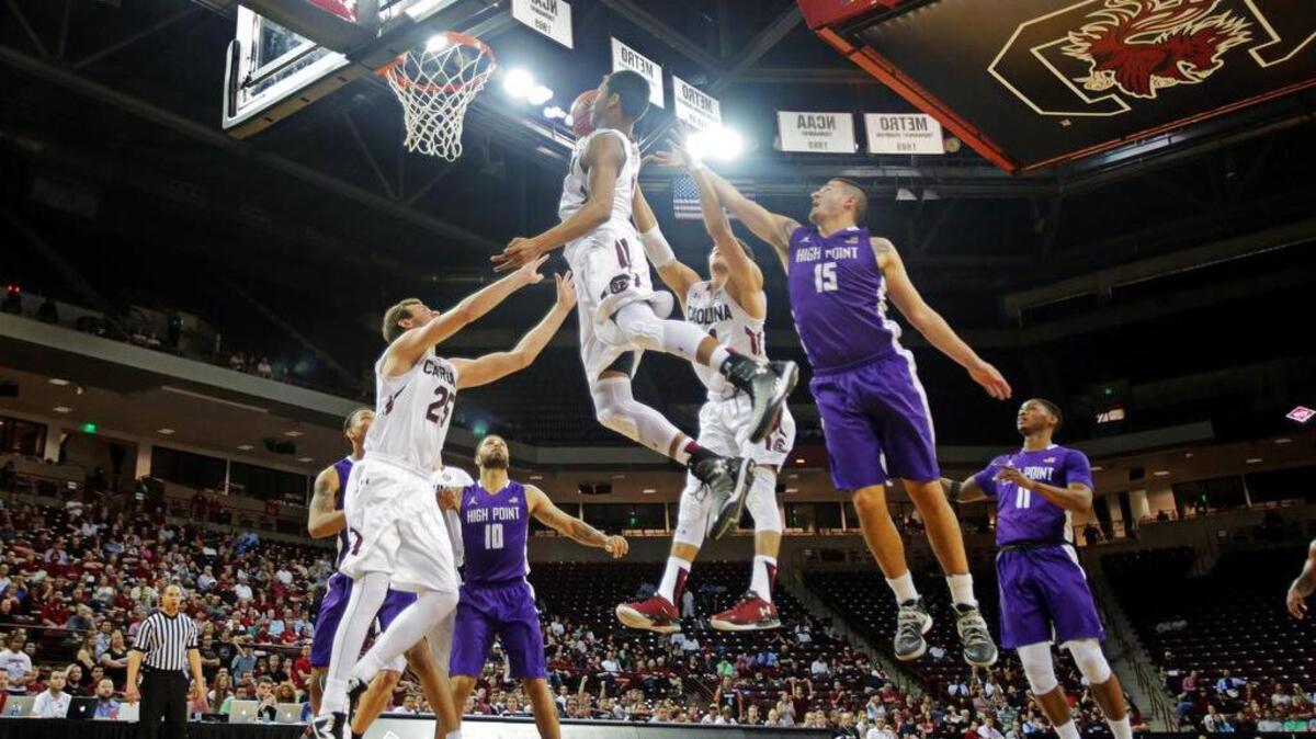 In this March 15, 2016 photograph, South Carolina's PJ Dozier skies for a rebound and a put back against High Point in the first round of the NIT at Colonial Life Arena.