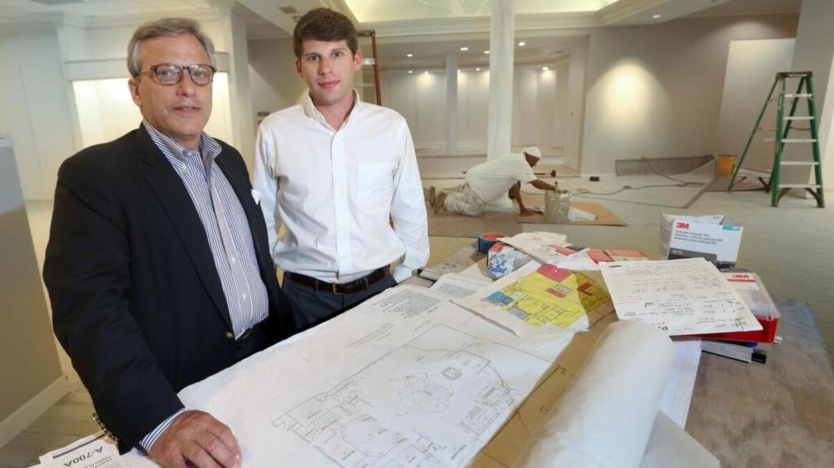 Bruce Greenberg and his son Andy are preparing for the reopening of Coplon’s in the Forest Drive building that suffered heavy flood damage during the October storm.