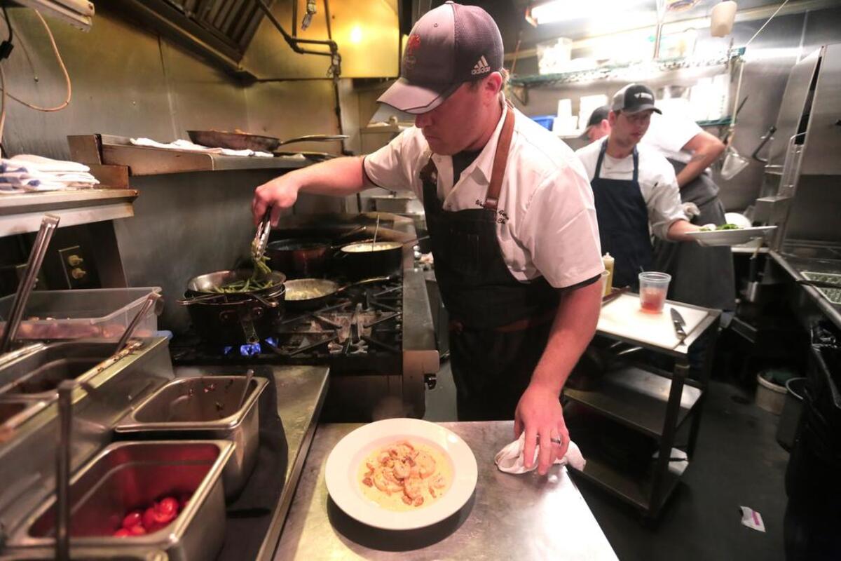 Motor Supply Company Bistro Chef Wes Fulmer works in the kitchen during Tuesday’s lunch.