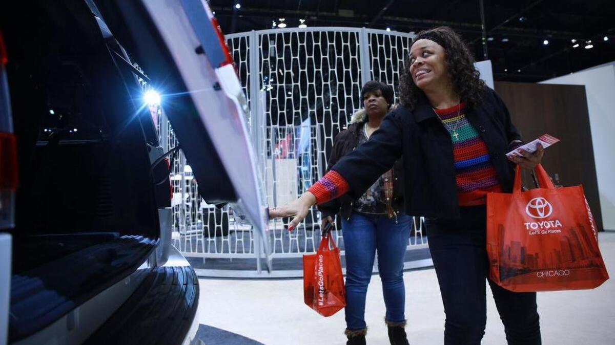 Jewell Smith checks out the back hatch of a Lincoln SUV at the Chicago Auto Show last year at McCormick Place in Chicago.