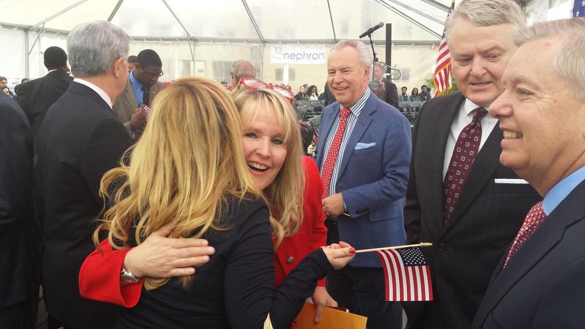 Nephron CEO Lou Kennedy hugs a supporter at a ceremony announcing 5 percent raises for the company’s employees. Her husband and company founder Bill Kennedy, left facing camera, S.C. Treasurer Curtis Loftis and U.S. Sen. Lindsey Graham look on.