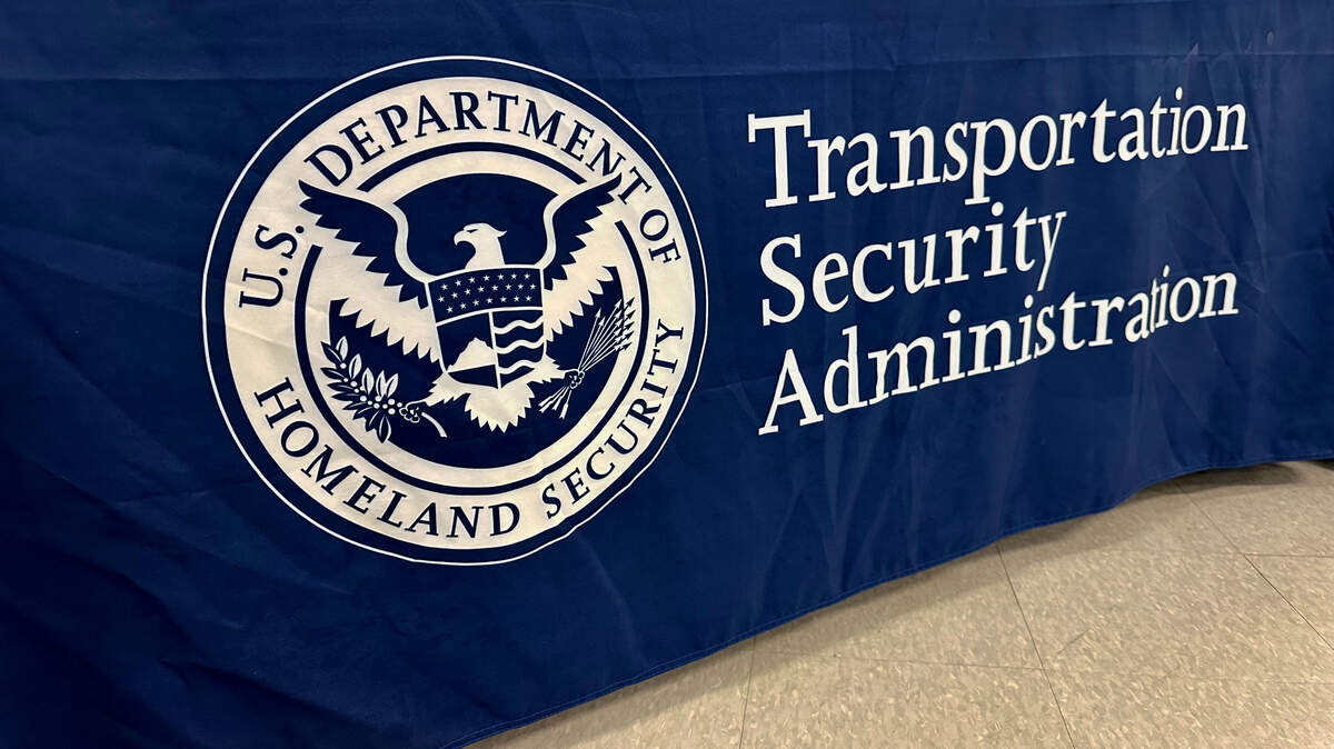 An airport traveler is accused of stripping naked while “in full view” of kids.