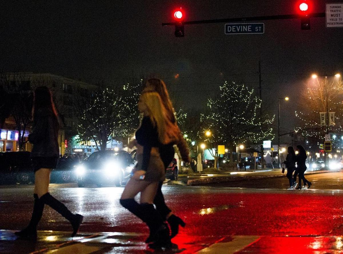 A group of people cross the intersection at Devine and Harden Street. Thousands of people will make their way through Five Points to various bars in one night.