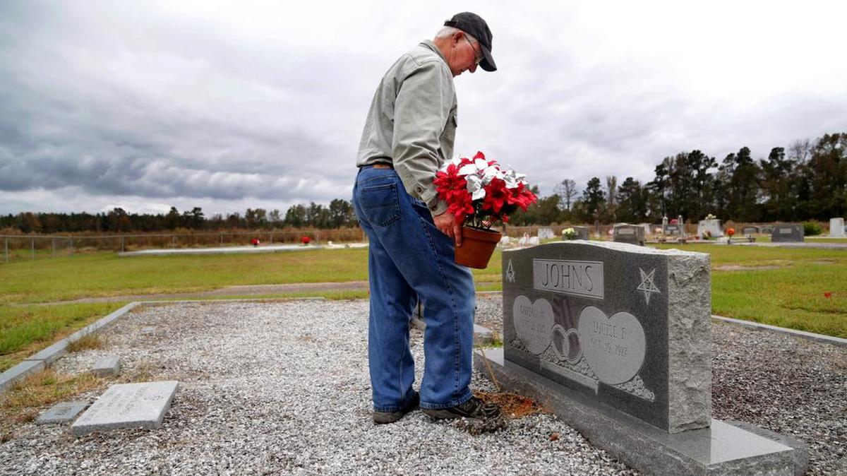 Dale Johns visits the grave of his father Gordon earlier this year. His father, who worked at Savannah River Site, died of colon cancer in 2002.