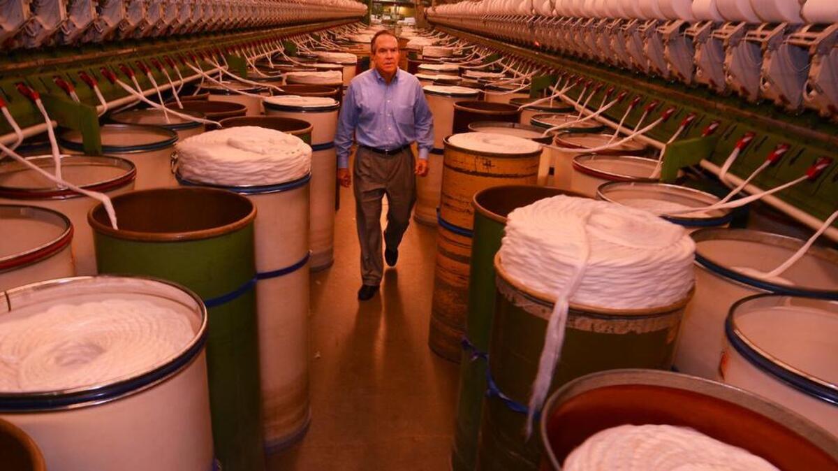 Rob Chapman, CEO of Inman Mills, walks through the textile plant in Enoree on Thursday. The uniforms be worn by American athletes at the opening ceremony of the Summer Olympics Friday night have a Spartanburg connection. Inman Mills workers partnered with Ralph Lauren to design the outfits Team USA wore during the ceremony.
