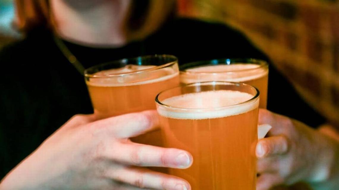 Bartender Amy Kampney serves glasses of Pineapple Kolsch at the Old Mill Brew Pub in Lexington.