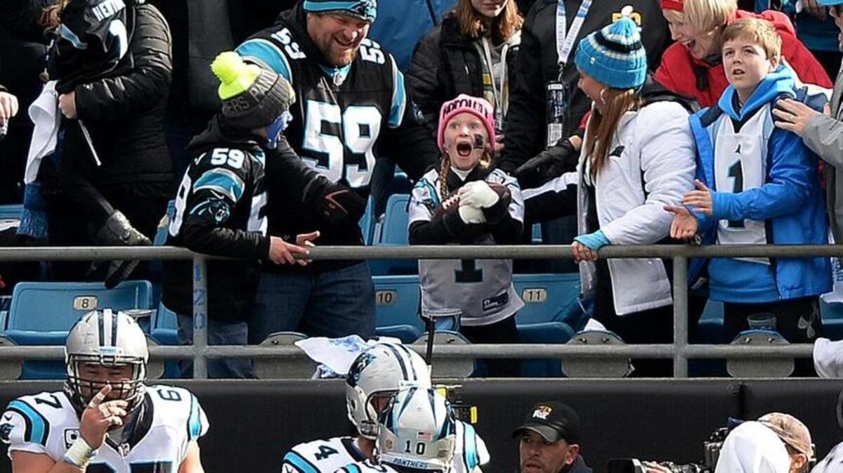 A stunned Isabella Bottomley, 8, reacts after Carolina Panthers running back Jonathan Stewart gave her the ball he’d carried into the end zone for the first touchdown against the Seattle Seahawks Sunday. See story on page 4A.