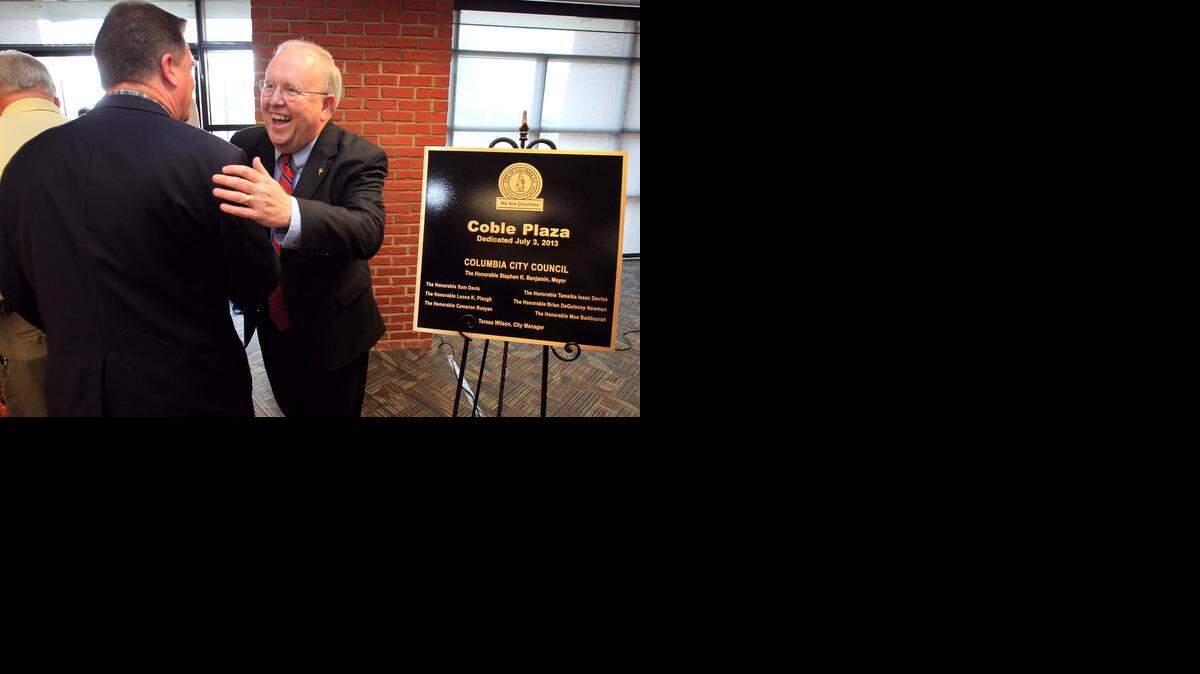 
Former Columbia mayor Bob Coble greets a guest after the dedication ceremony for Coble Plaza, just outside EdVenture children’s museum, in August 2013.
