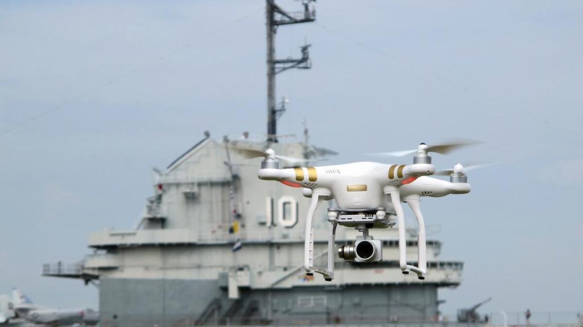 A drone, similar to those that will be taking up-close pictures of Fourth of July fireworks at the Patriots Point Naval and Maritime Museum in Mount Pleasant, is flown near the aircraft carrier USS Yorktown at the museum last week. The up-close video will be projected on the sides of the aircraft carrier during the Independence Day celebration.
