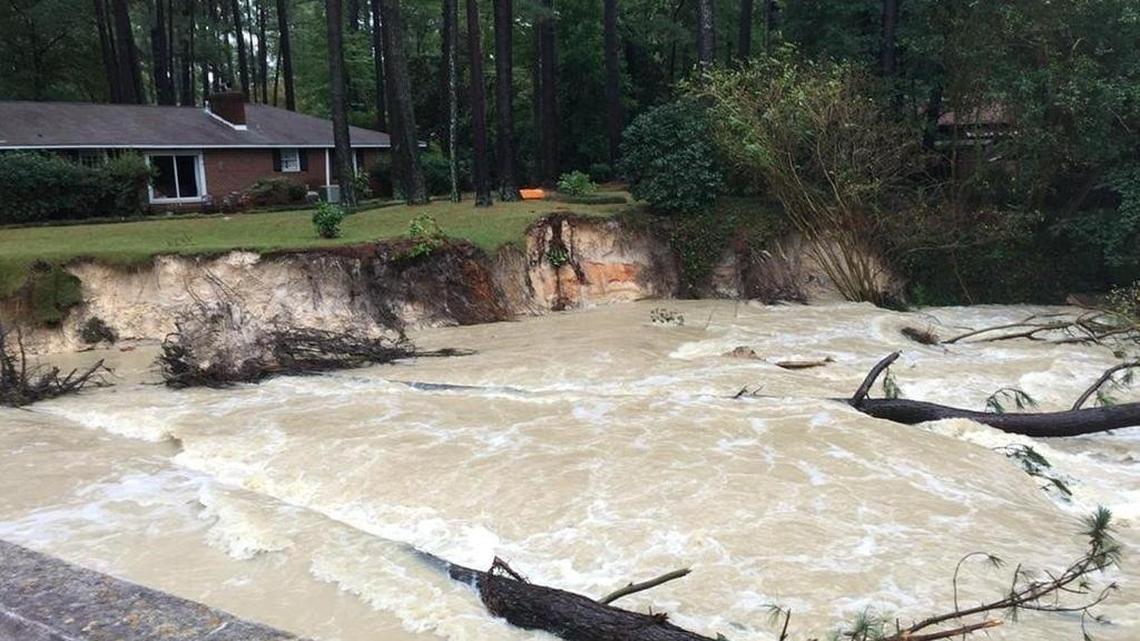 Rushing water eroded parts of yards below the blown-out dam at Lower Rockyford Lake after the historic rain storm in October.