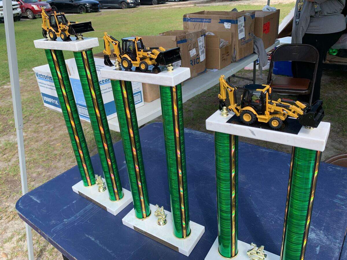 Trophies for the winners of the Midlands Backhoe Roadeo, May 24, 2024. The trophies are topped with plastic backhoes.