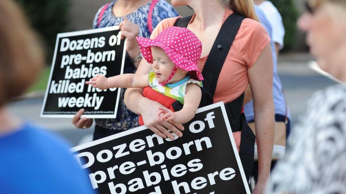 
Lisa Read of Lexington and her 13-month-old daughter Hadley Read joined more than a hundred protesters gathered outside Planned Parenthood in Columbia Saturday morning.
