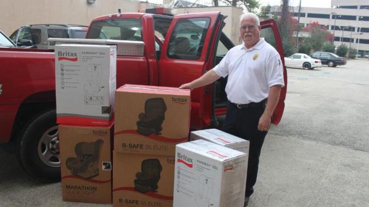 Eddie Gardner of Safe Kids Kershaw prepares to load donated car seats by Britax.