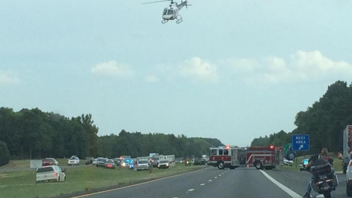 
A helicopter lands on Interstate 77 in Chester County on Sunday. Two choppers were needed to fly out two people who were severely burned when their motorcycle was struck by a car near mile marker 65. 
