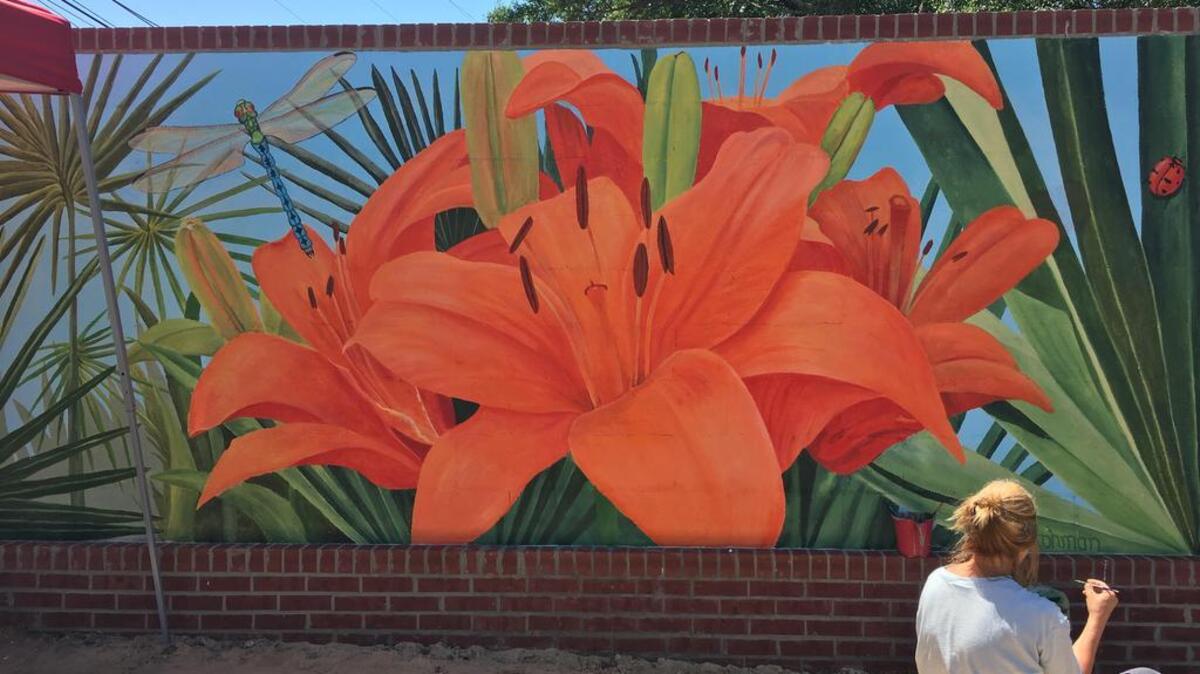 Artist B.A. Hohman works on the mural that is part of a public art display taking shape near West Columbia’s riverfront.
