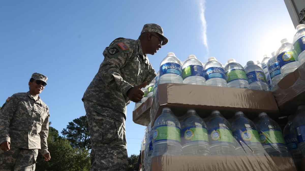 
Residents line up for water distribution at Lower Richland High School. 

