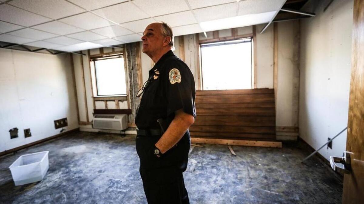 Forest Acres Police Chief Gene Sealy walks through the gutted police station.