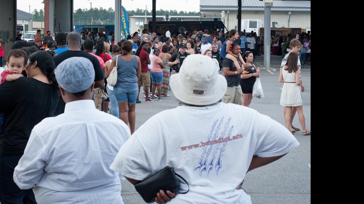 
People wait in line at the first annual South Carolina Food Truck Festival & Craft Beer Festival at the South Carolina State Farmers Market on Sunday. Festival organizer Anne-Marie Aigner estimated attendance at 12,000 while admitting it was probably closer to 15,000. Many festival-goers reported standing in individual lines for over an hour.

