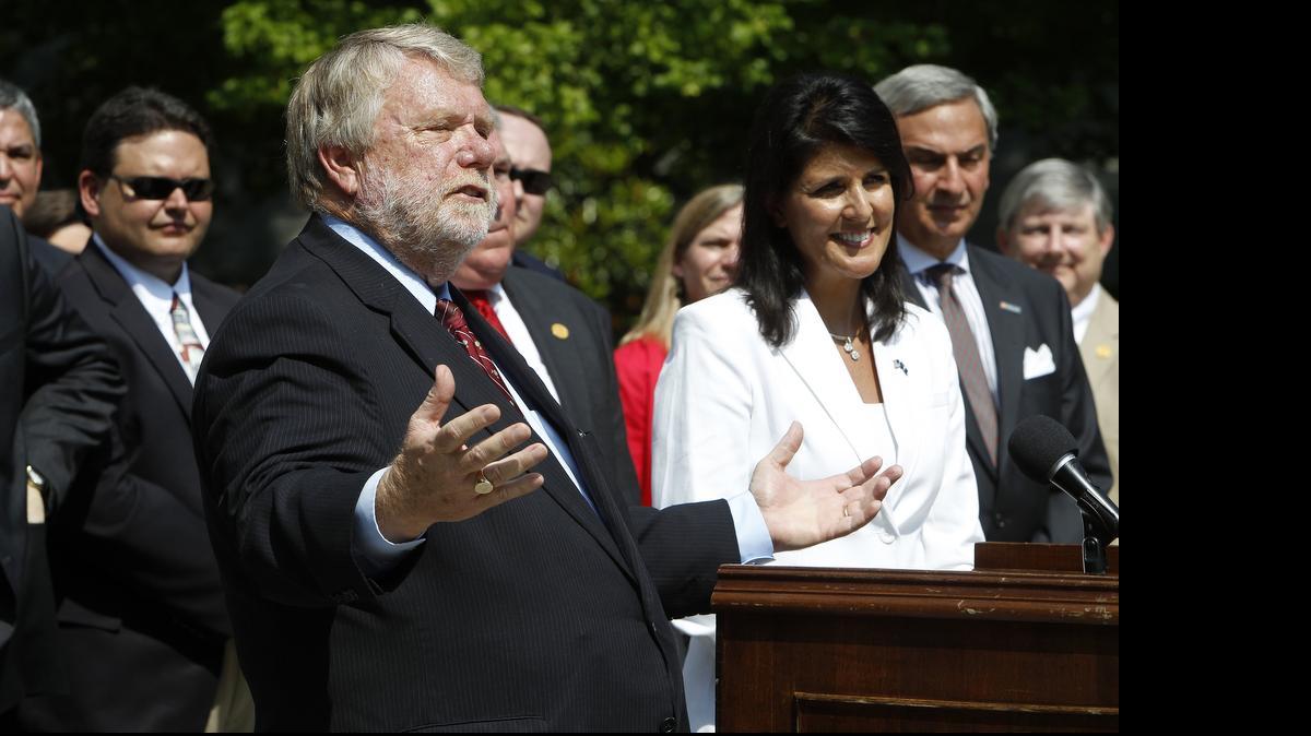 
Commerce Secretary Bobby Hitt is joined by Gov. Nikki Haley and state officials outside the Governor's Mansion Complex as they make it official by announcing Volvo will build a $500 million factory in Berkeley County to produce 100,000 cars a year. 
