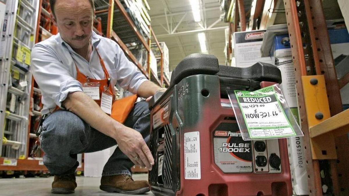 File photo. Hardware supervisor Dwayne Shope, demonstrates features on a floor model generator at a Home Depot store in Orlando, Fla., Thursday, May 17, 2007.
