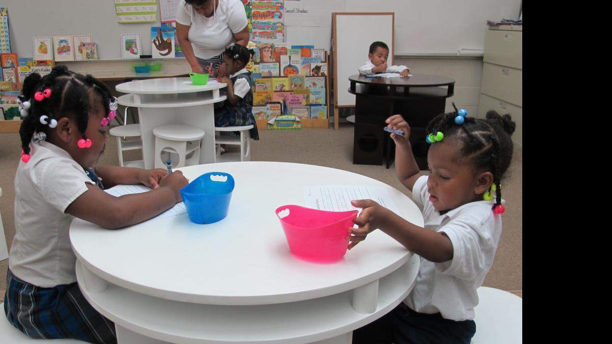 
Janiya Young and Maya McCloud of the pre K-3 and pre-K 4 class work at their new tables.
