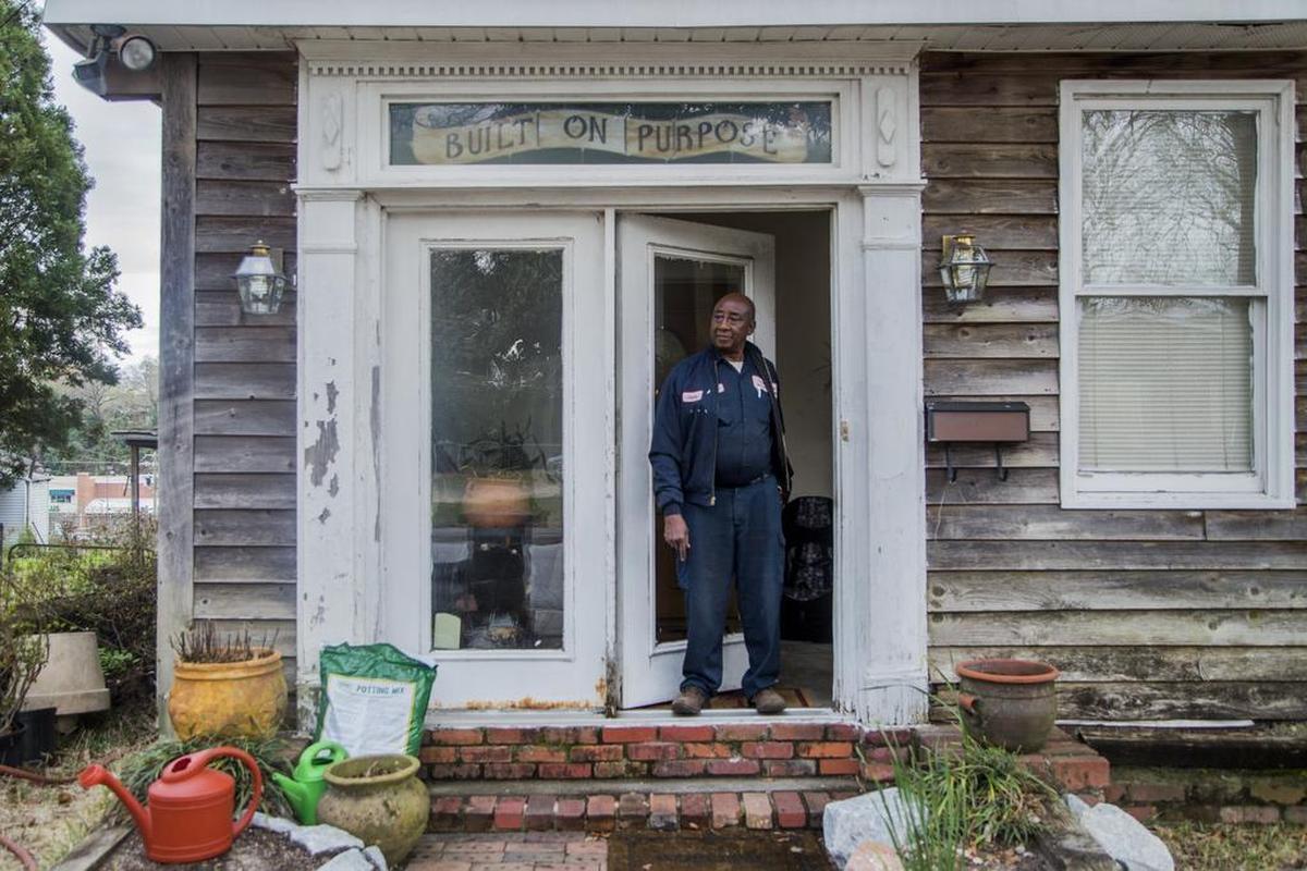 Olufemi Olulenu looks out to the street from his as a friend drives away after saying hello in the Martin Luther King neighborhood. Olulenu bought his house in 1995 for $11,000 dollars. The traditionally black neighborhood has seen an influx of University of South Carolina students moving into the neighborhood. Oluleno worries about their safety coming back into the neighborhood from drinking all night.