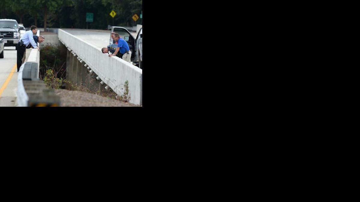 
Investigators look over the bridge on State 93 over the Seneca River in Clemson Tuesday, September 23, 2014 where the body of Clemson student Tucker W. Hipps was found. 
