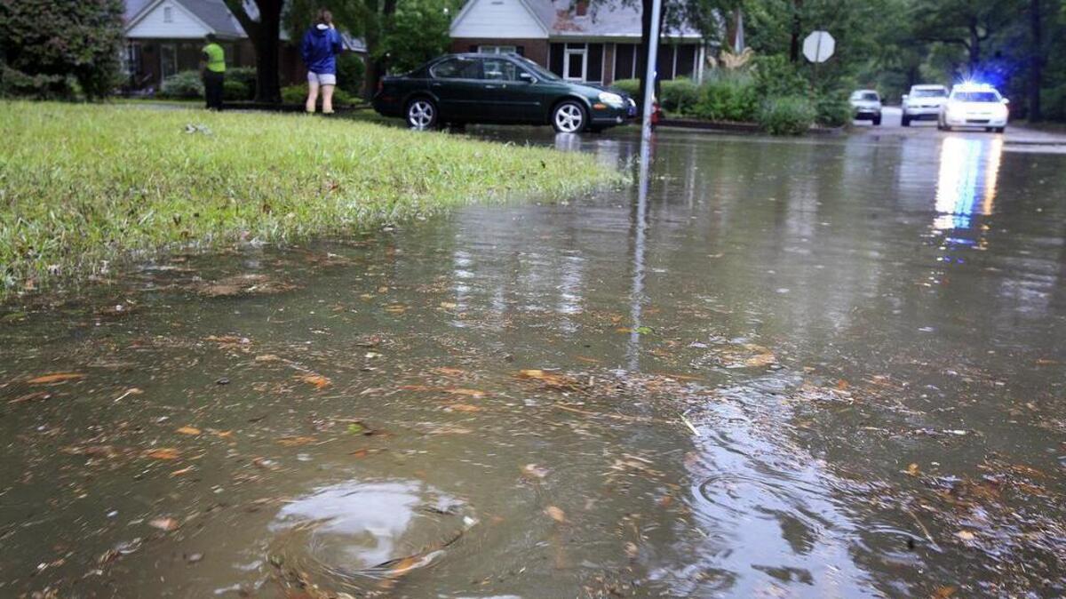 FILE PHOTO: Whirlpools of water circle storm drains as the water starts to recede from the streets of Columbia after a 2011 flash flood.