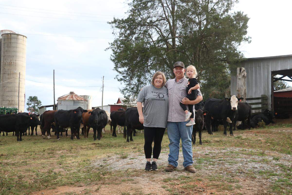 Troy Dobbins and his wife, Taylor, and daughter, Caroline, on their farmland in Anderson County.