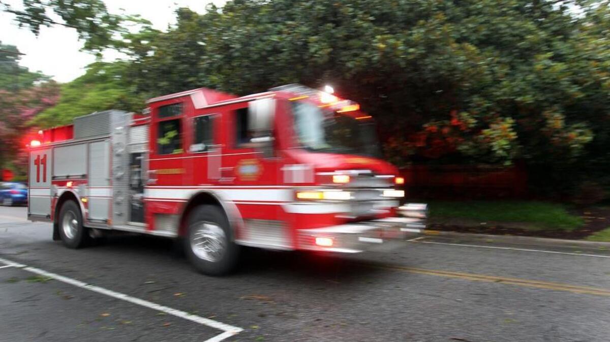 A fire truck heads down Woodrow Street in the Shandon area of Columbia.