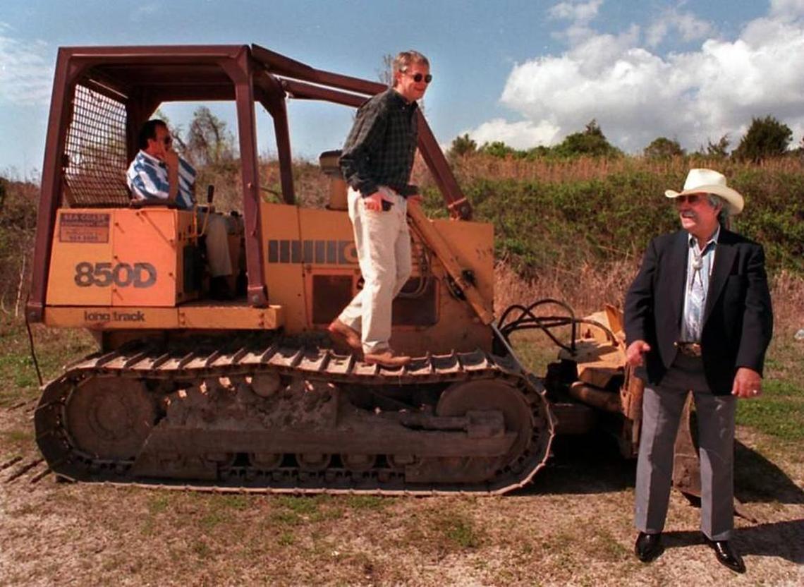 Standing at the future site of the Catawba Indian Nation’s bingo parlor in March 1997, Chief Gilbert Blue, right, laughs along with consultant Bobby Price while talking about the previous night’s vote by the North Myrtle Beach City Council. Seated in bulldozer is Catawba Tribal member Carson Blue.