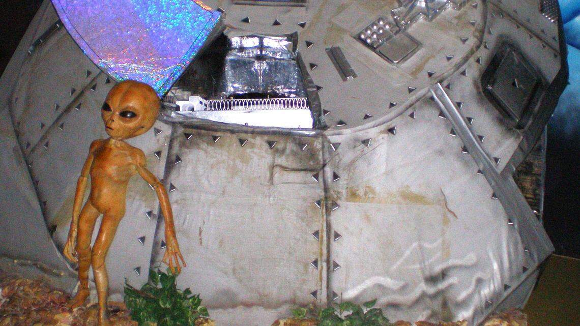 This photo taken in December 2006 at the Area 51 exhibit at the Alien Zone in Roswell, N.M., shows an alien standing outside a crashed spaceship. (AP Photo/Justin Norton)