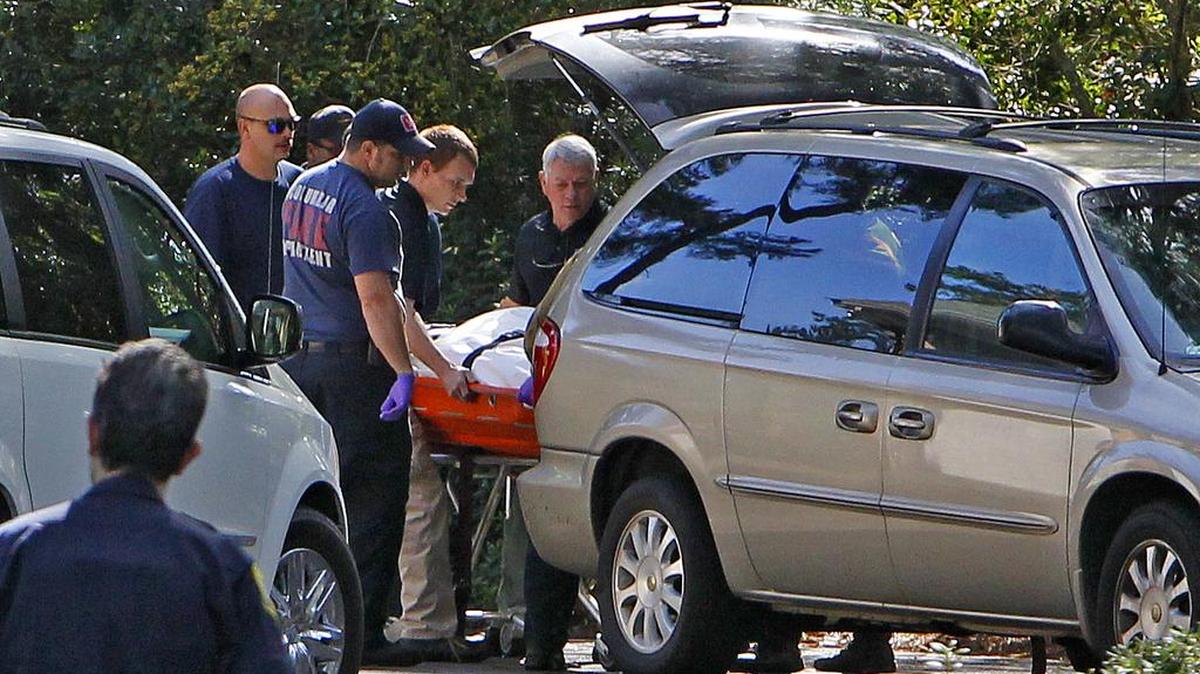 Richland County coroner’s officials load a body pulled from Cary Lake behind a home on Trenholm Road in Columbia during the October 2015 flooding.