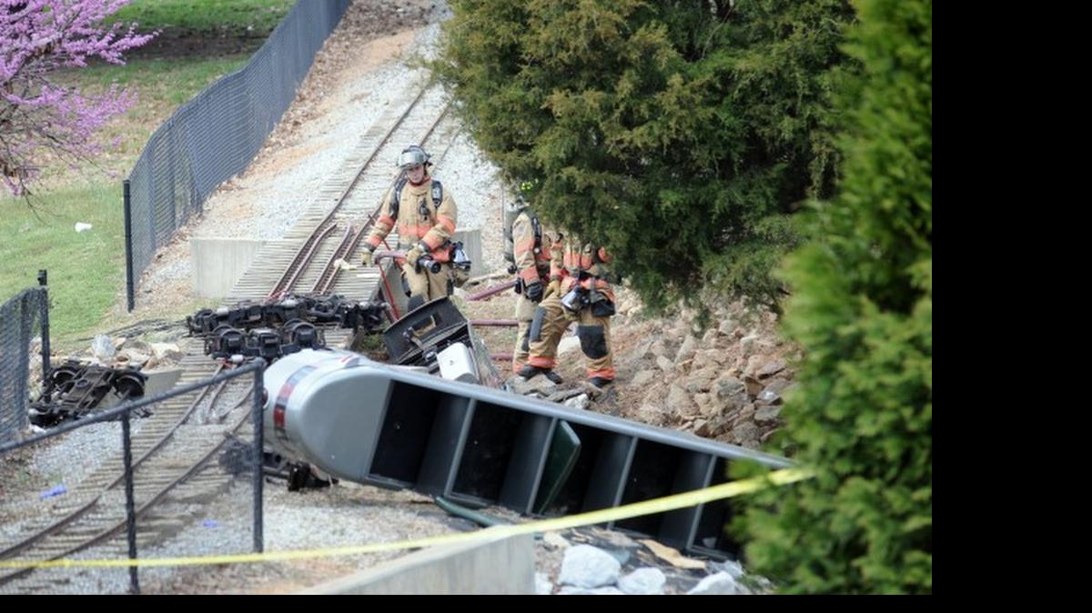 Rescue workers look over the scene of the children’s train ride accident in Spartanburg.
