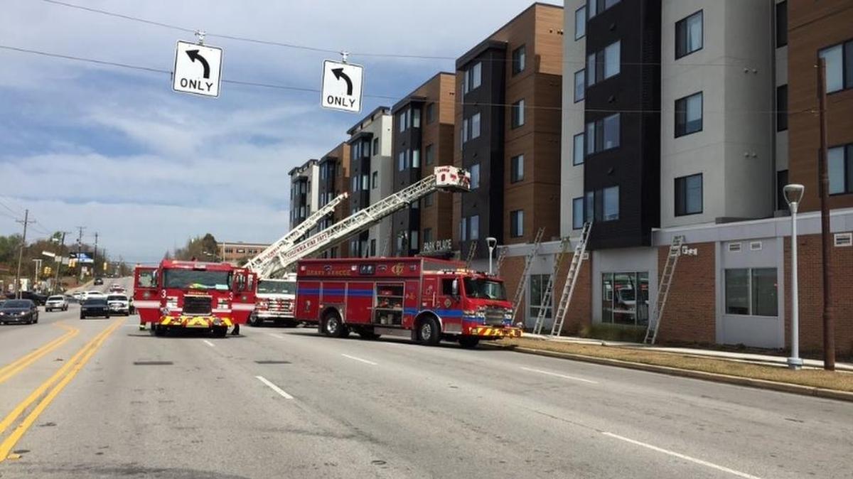 Firefighters remain on scene after extinguishing a fire at the Park Place student housing complex at the corner of Blossom and Huger streets.