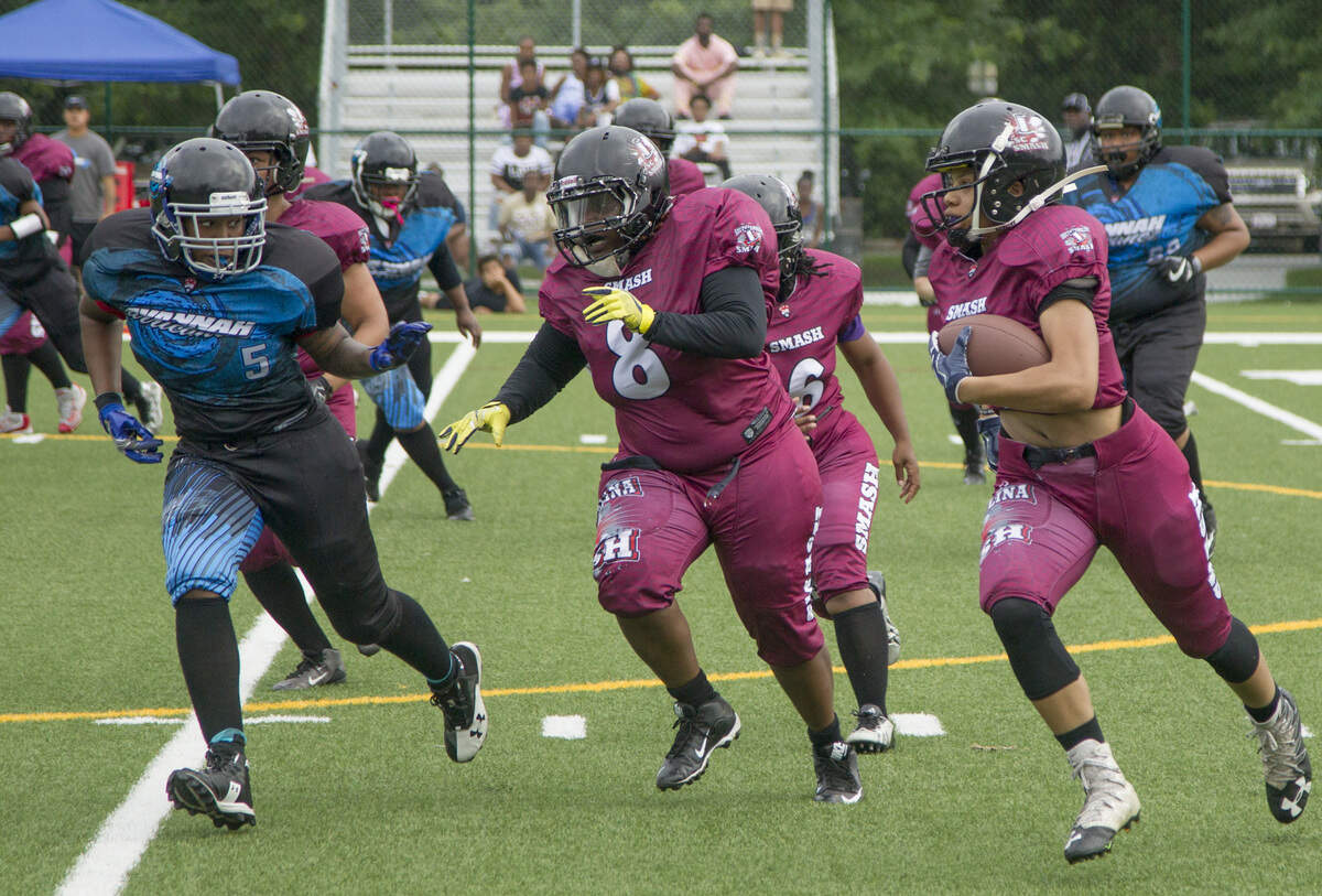 S.C. Smash’s Christina Davis, right, carries as Rosalyn Martin (8) blocks for her during the game against the Savannah Hurricanez in Savannah, GA. The Smash will travel hundreds of miles to face other teams in the Women’s Football Alliance.