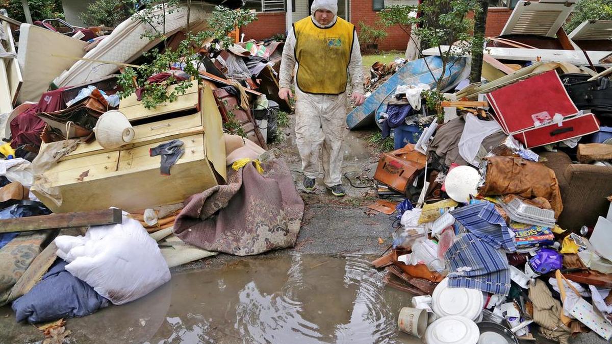 
Alex Carter, a volunteer with the Church of Jesus Christof Latter-day Saints, takes a break after a morning working inside a home on Glenhaven Drive in Columbia on Saturday.
