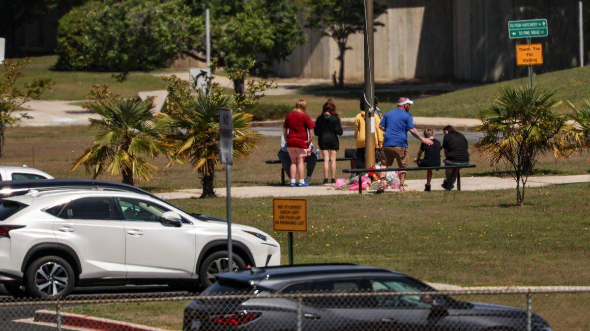 People gather at Pine Ridge Middle School on April 18, 2025 to mourn Jose Maria Gonzalez-Linares, a 13-year-old student who was killed in a school bus crash the day before.